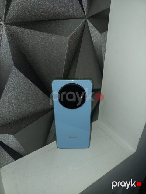 Redmi smartfon. Cihaz açıq mavi rəngdədir və arxa hissəsində böyük