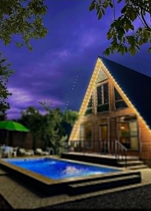 A-frame üslubunda, taxta memarlığa malik geniş kottec. Xarici məkan